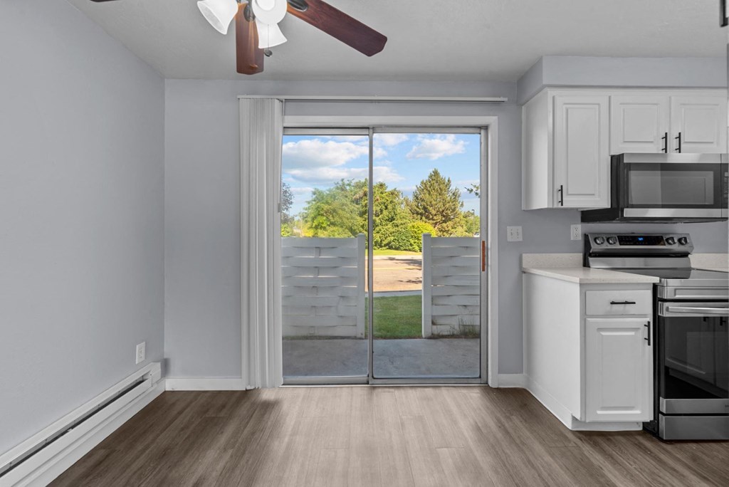 an empty kitchen with a door to a patio with a view