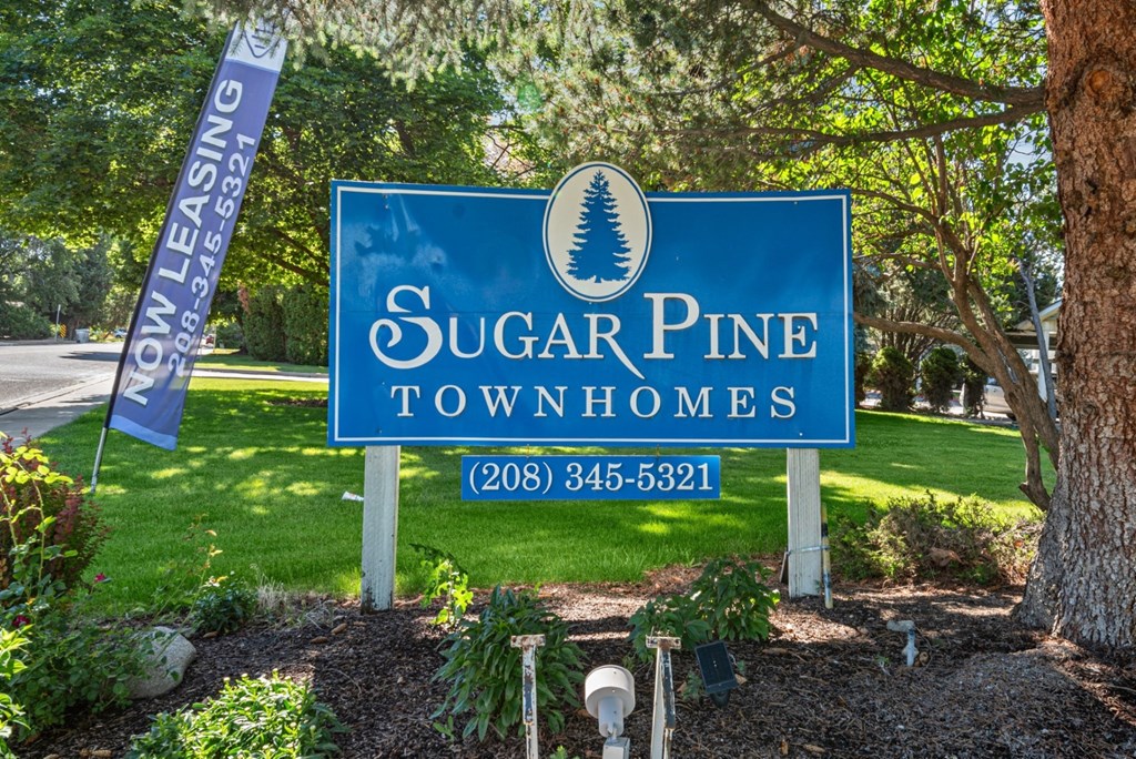 a sugar pine townhomes sign in the front yard of a house