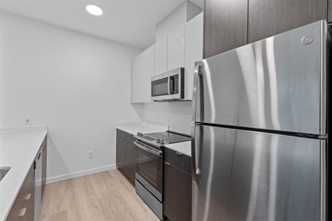 a kitchen with stainless steel appliances and white cabinets