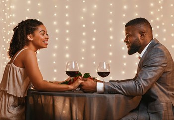 Man and Woman Holding Hands and Smiling while Having Wine Together - Photo Gallery 2