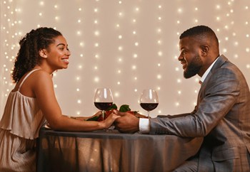 Man and Woman Holding Hands and Smiling while Having Wine Together Man and Woman Holding Hands and Smiling while Having Wine Together - Photo Gallery 2