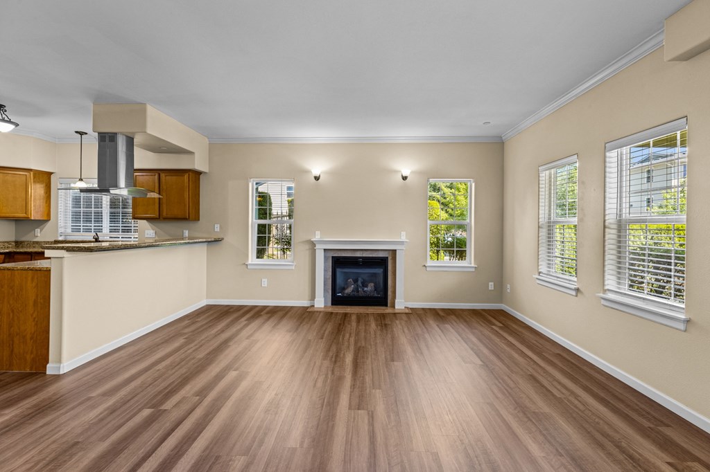 Little Tuscany Apartments & Townhomes - Fireplace in Living Room, Breakfast Bar, Wood Vinyl Plank Flooring - located in Olympia
