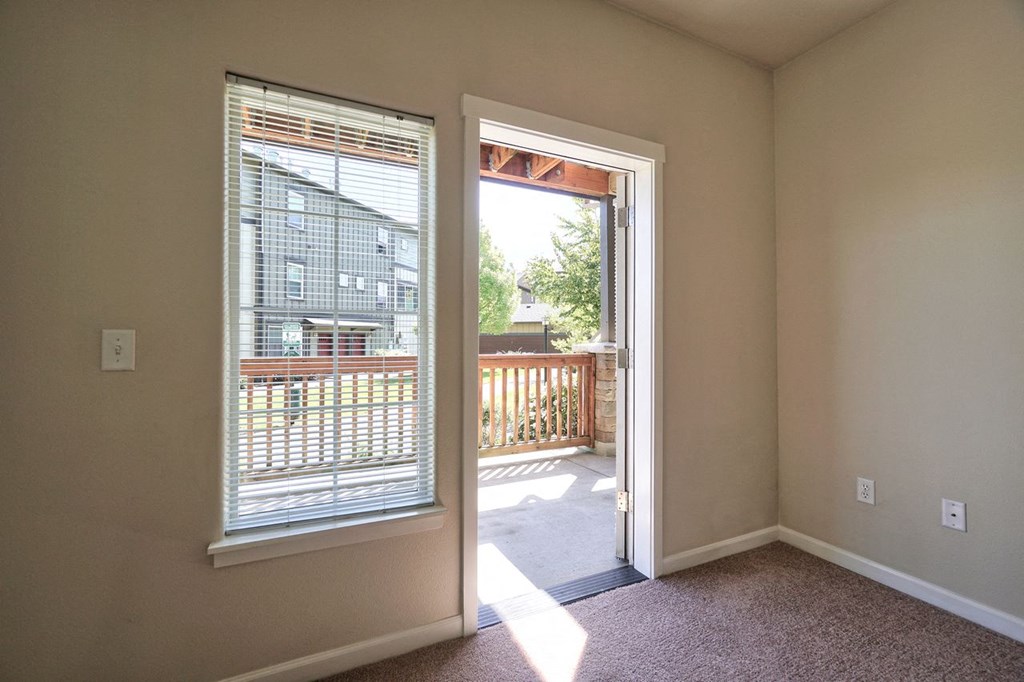 a living room with a door leading to a balcony