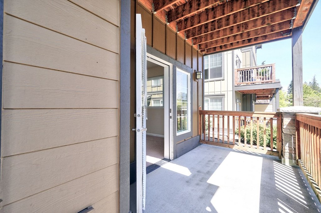 the front porch of a house with a open door