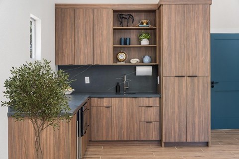 A kitchen with wooden cabinets and a black countertop.