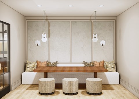 A modern dining room with a wooden table and four stools.