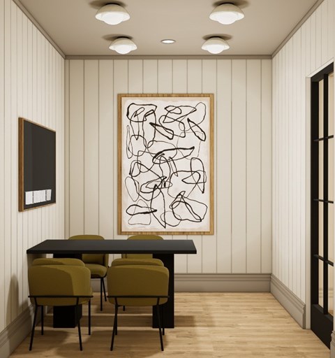 A dining room with a table and chairs and a framed picture on the wall.