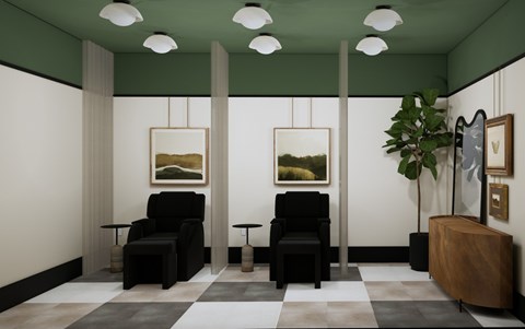 A room with two chairs and a table with a plant on it.