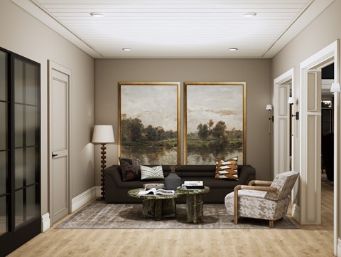 A living room with a large painting on the wall and a coffee table in the center.