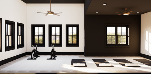 A room with a white floor and black walls has exercise bikes and a yoga mat.