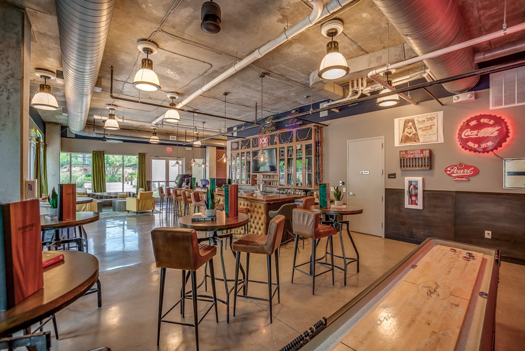 Discovery at the Realm Apartments club room with bar stool seating and game boards