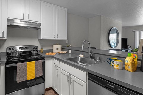 a kitchen with stainless steel counter tops and a sink