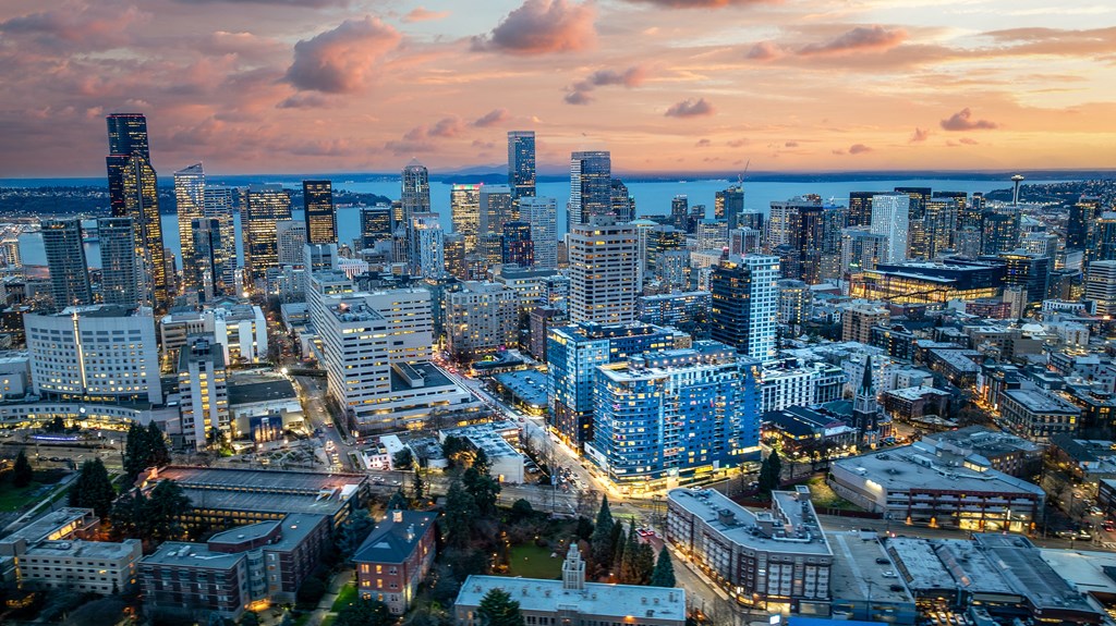 a cityscape of a city at sunset