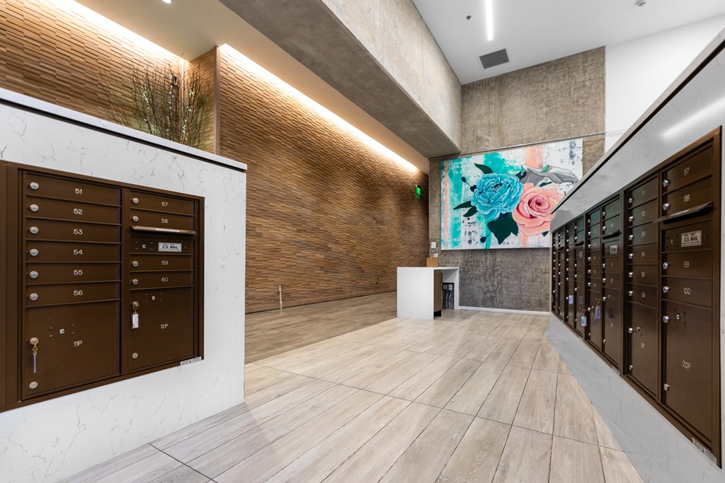 a lobby with lockers and a painting on the wall