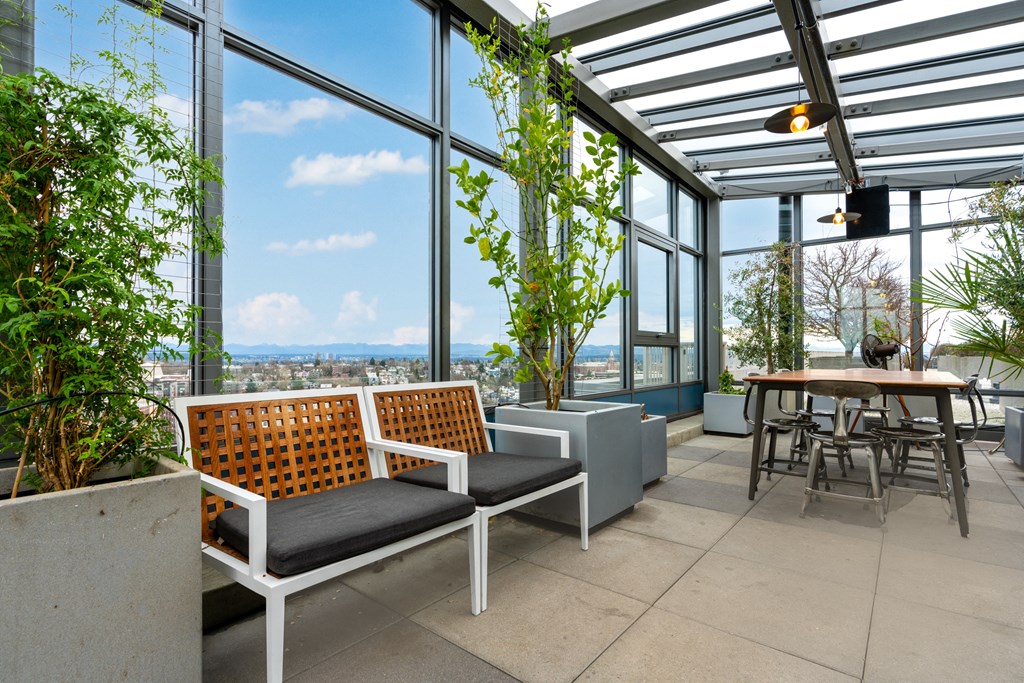 an outdoor patio with chairs and tables and glass ceilings