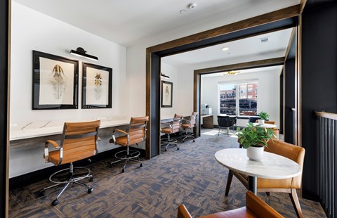 A conference room with a table, chairs, and framed pictures on the wall.