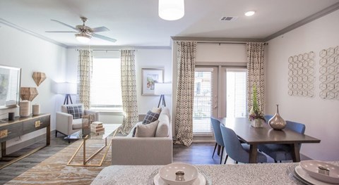 The Flats at Shadowglen Apartments in Manor, TX Model Kitchen and Living Room