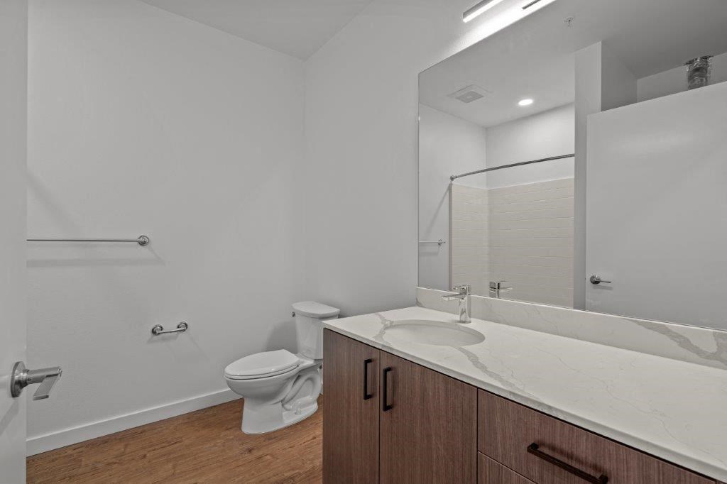 a bathroom with a toilet and a sink and a mirror
