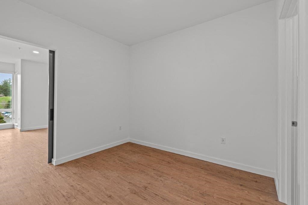 a living room with a wooden floor and white walls