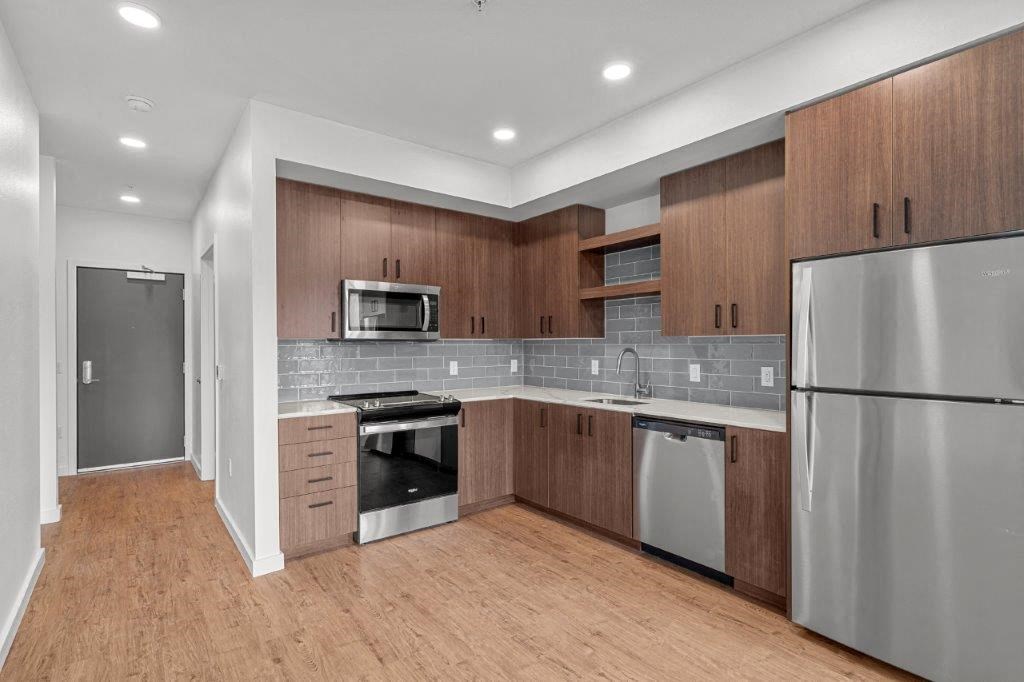 a kitchen with stainless steel appliances and wooden cabinets