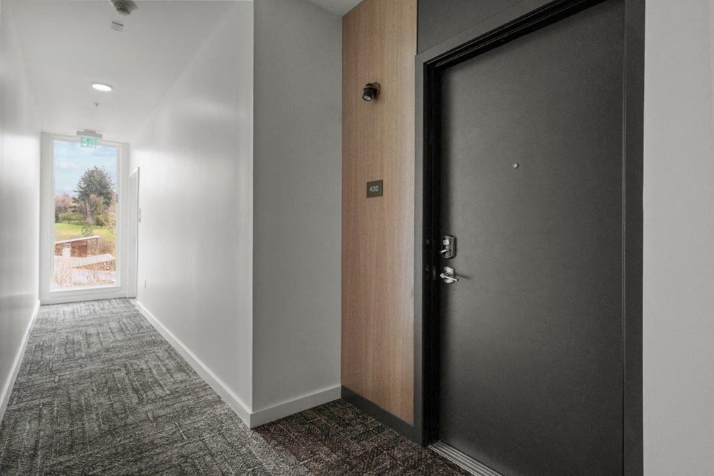 a door in a room with a hallway and a glass door