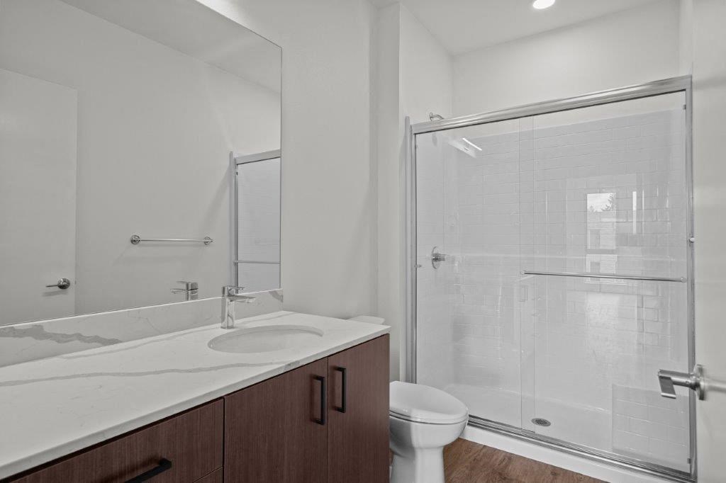 a bathroom with a sink and a shower and a toilet