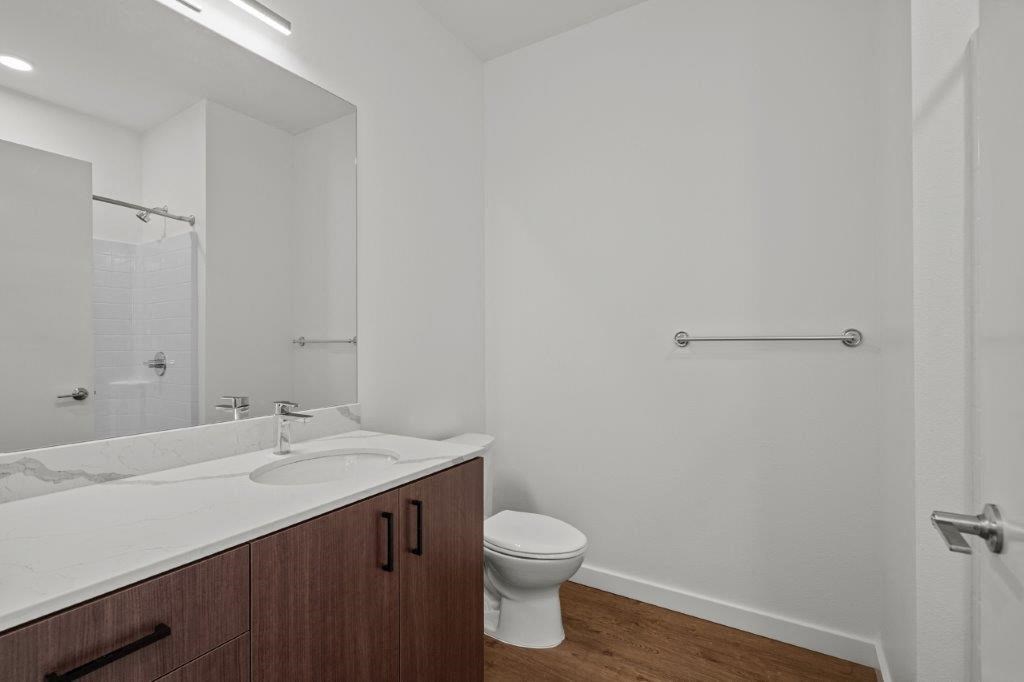 a bathroom with a toilet and a sink and a mirror