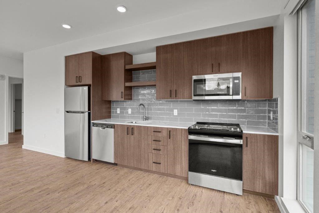 a kitchen with a stove and a refrigerator