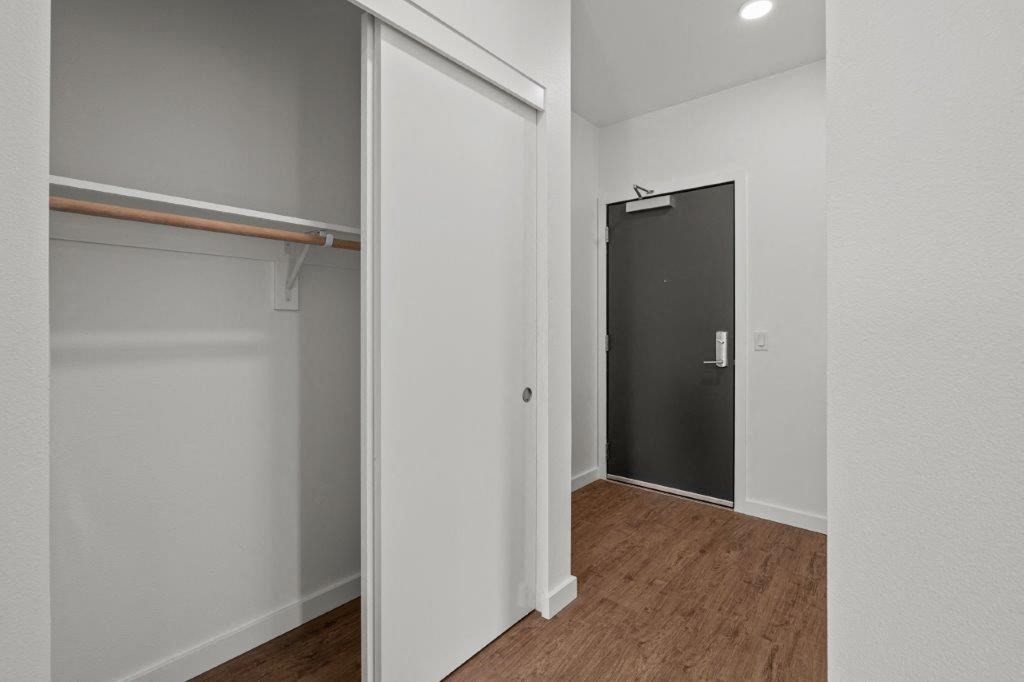 a bedroom with a closet and a black door