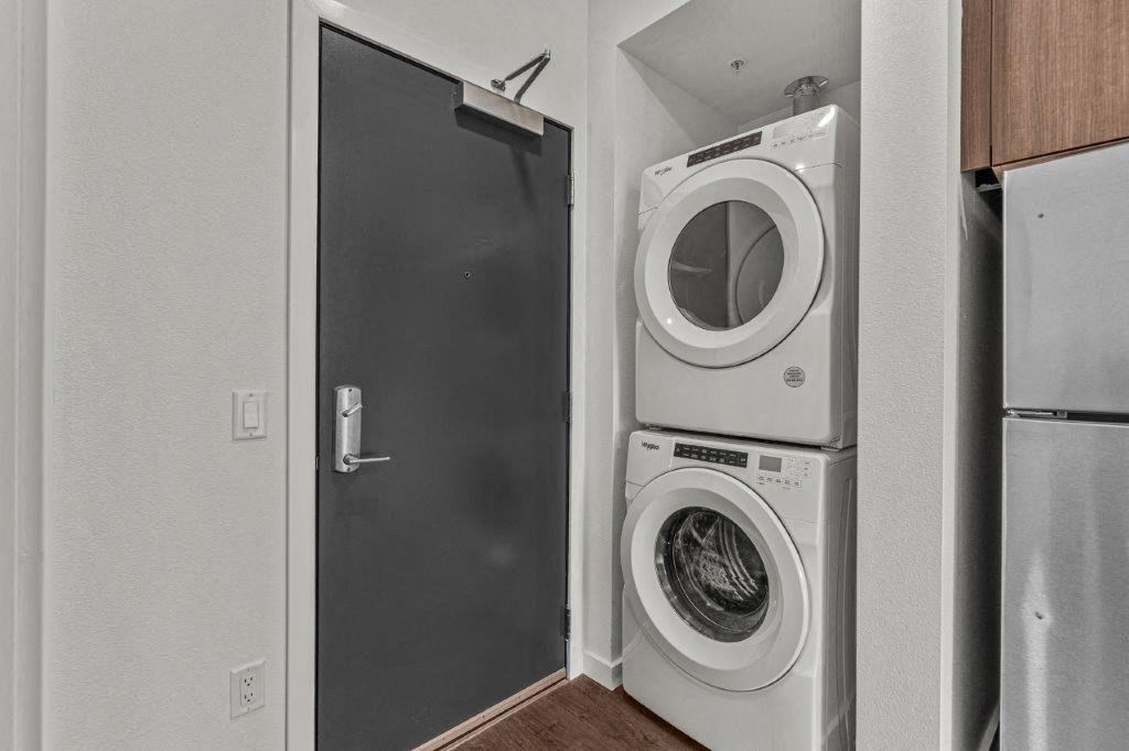 a white washer and dryer in a laundry room with a door