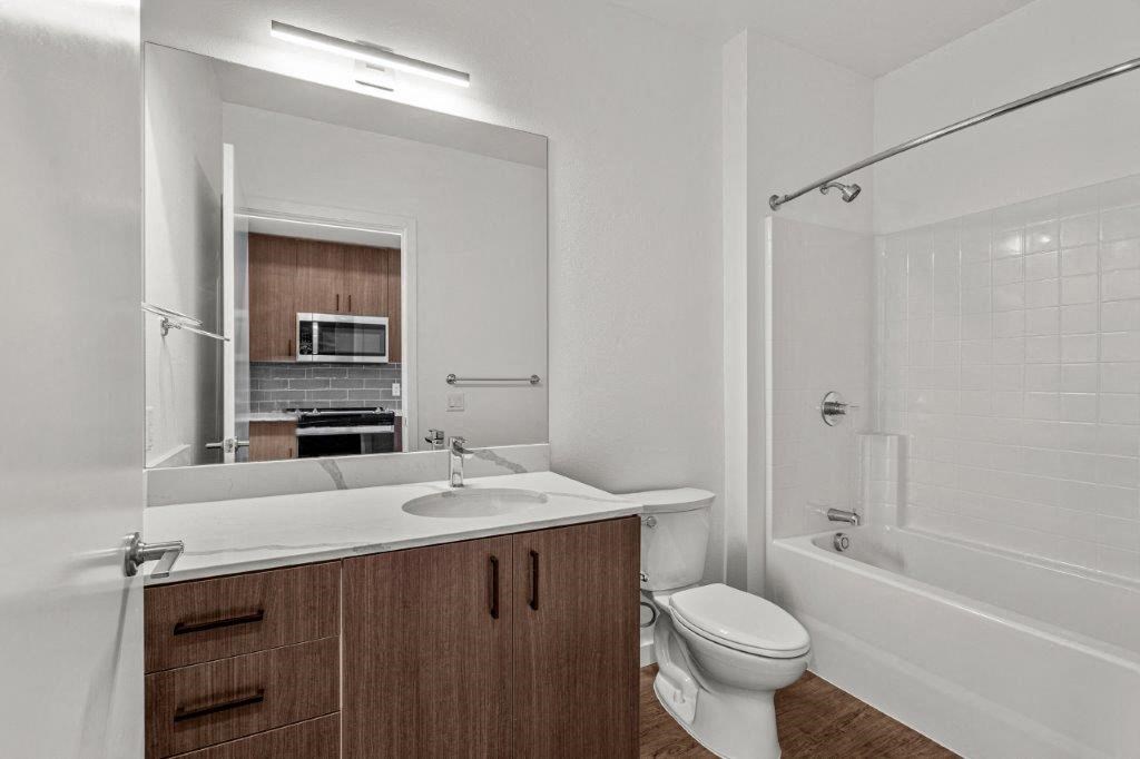 a bathroom with a sink toilet and a mirror