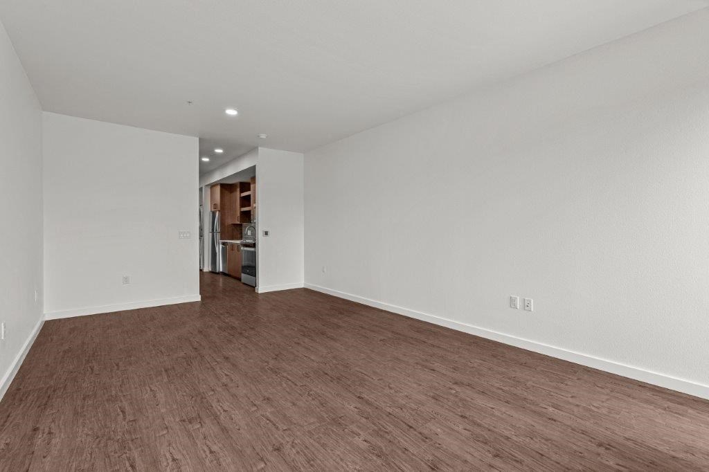 an empty living room with a hard wood floor