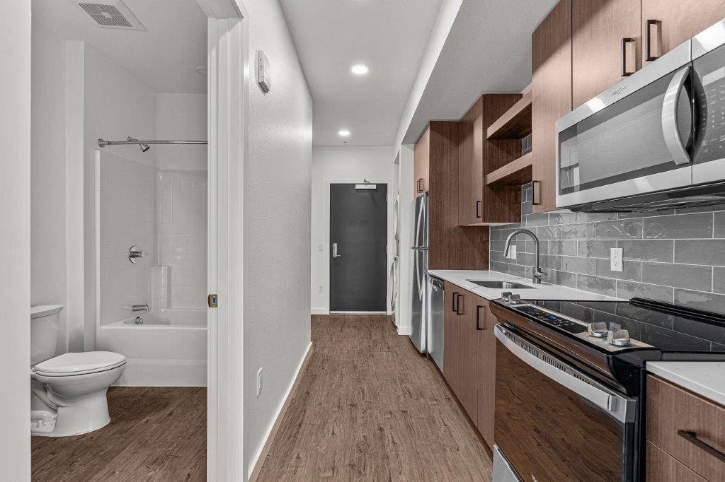 a kitchen and a bathroom with a toilet and a sink