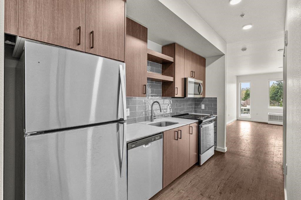 a kitchen with a refrigerator and a sink