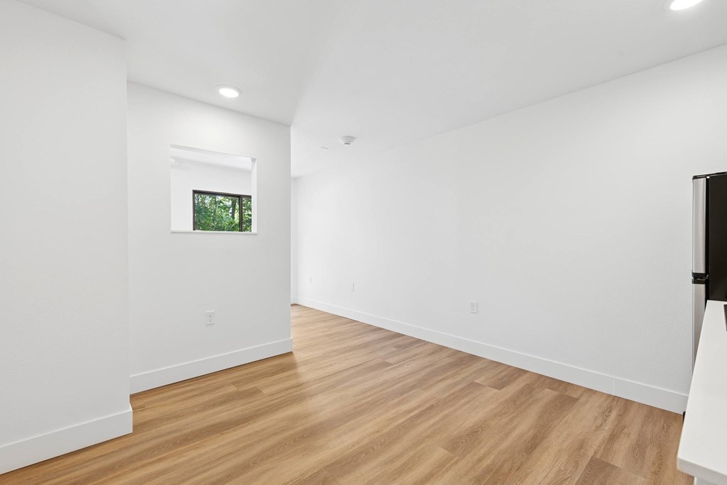 A room with wooden floors and white walls.
