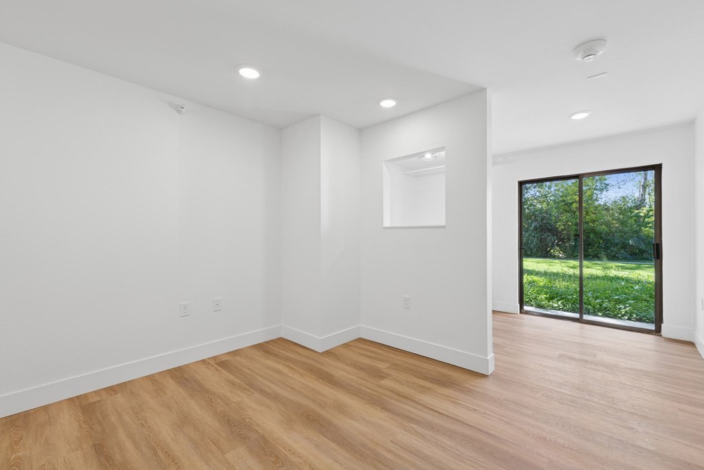 A room with wooden floors and white walls.