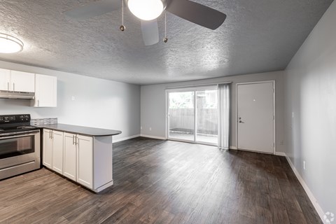 A spacious kitchen with white cabinets and a stainless steel oven.