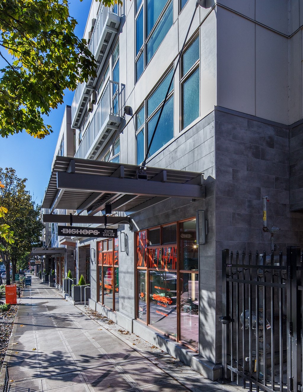 a street view of a building with a sidewalk in front of it