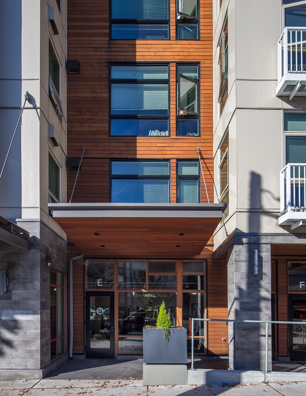 a building with a glass front door and a wood facade
