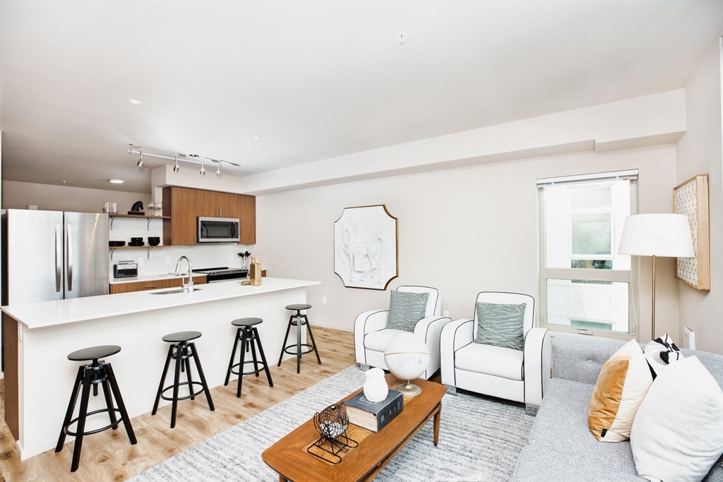 a living room with a kitchen and a couch