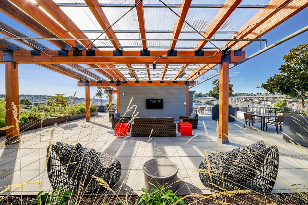 a covered patio with furniture and a television