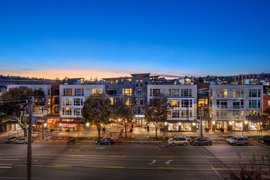 an aerial view of a city street at night with buildings