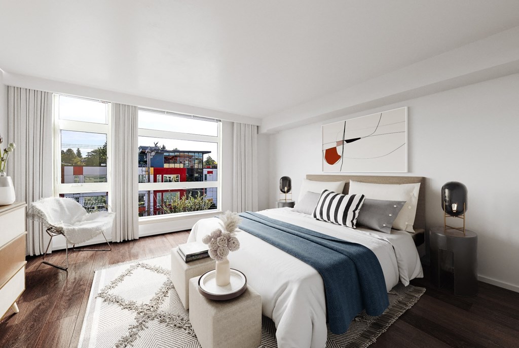 a bedroom with a bed and a large window