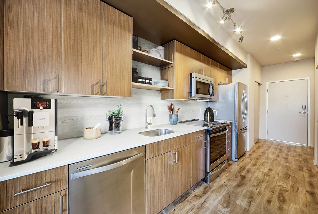 a kitchen with wooden cabinets and stainless steel appliances