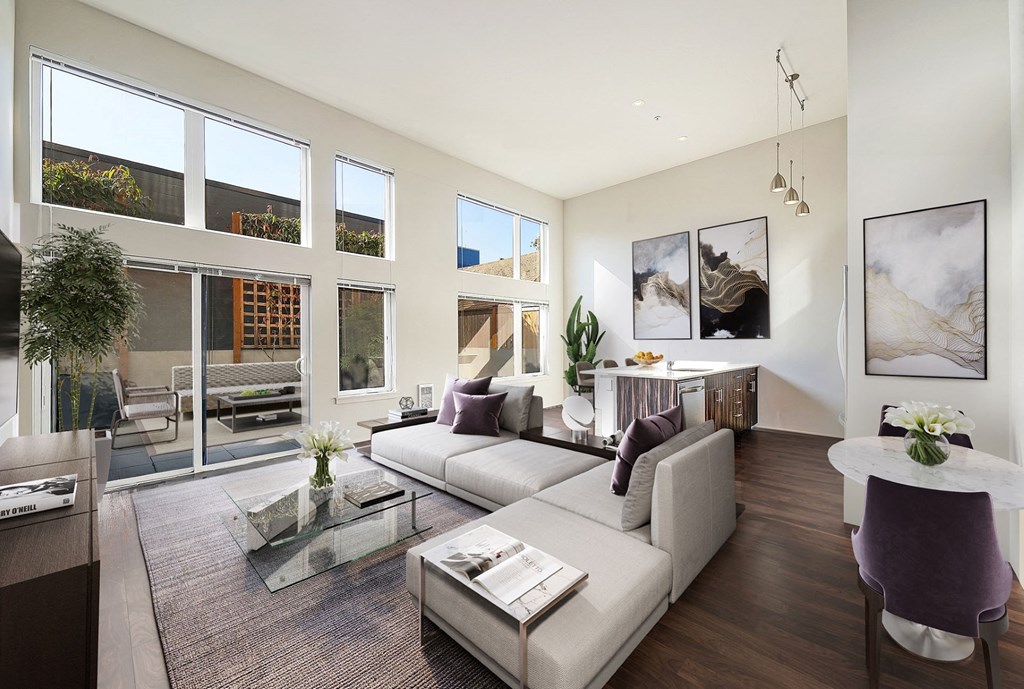 The Hayes on Stone Way Apartments  living room with a couch and a coffee table and large windows