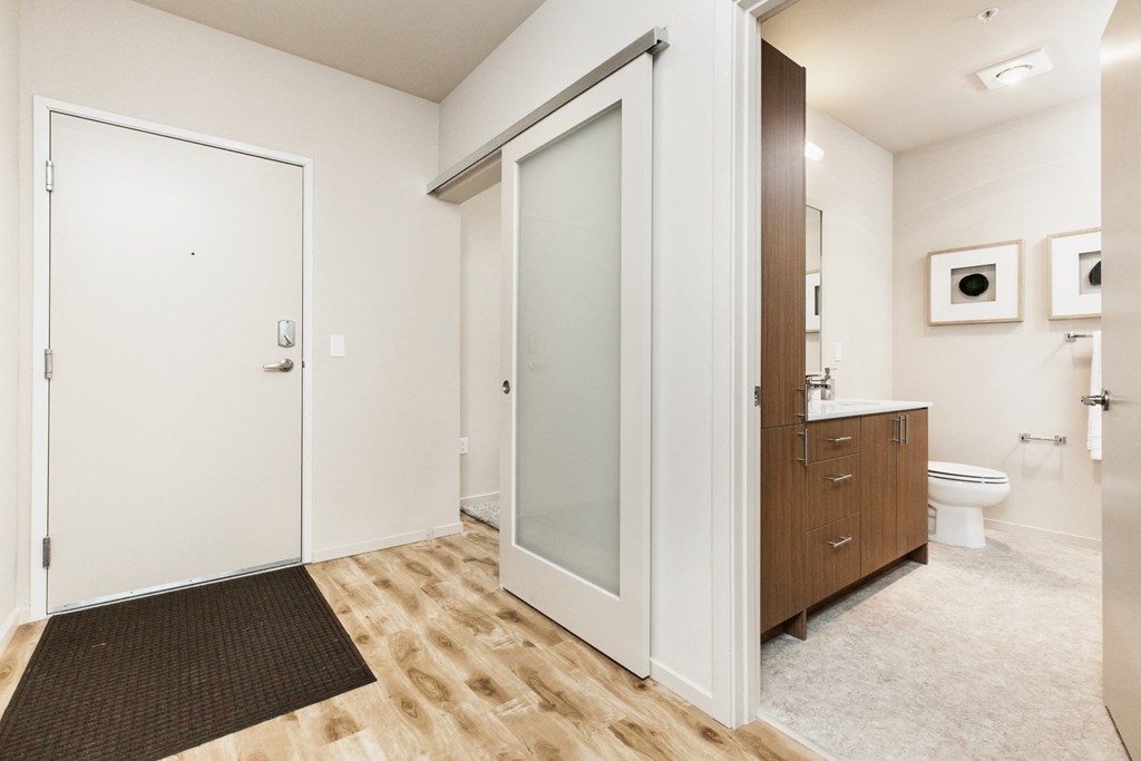 a bathroom with a shower and a sink and a toilet