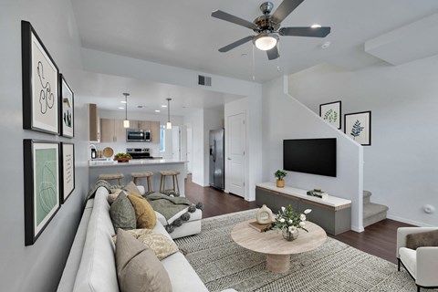 A living room with a white couch and a coffee table.