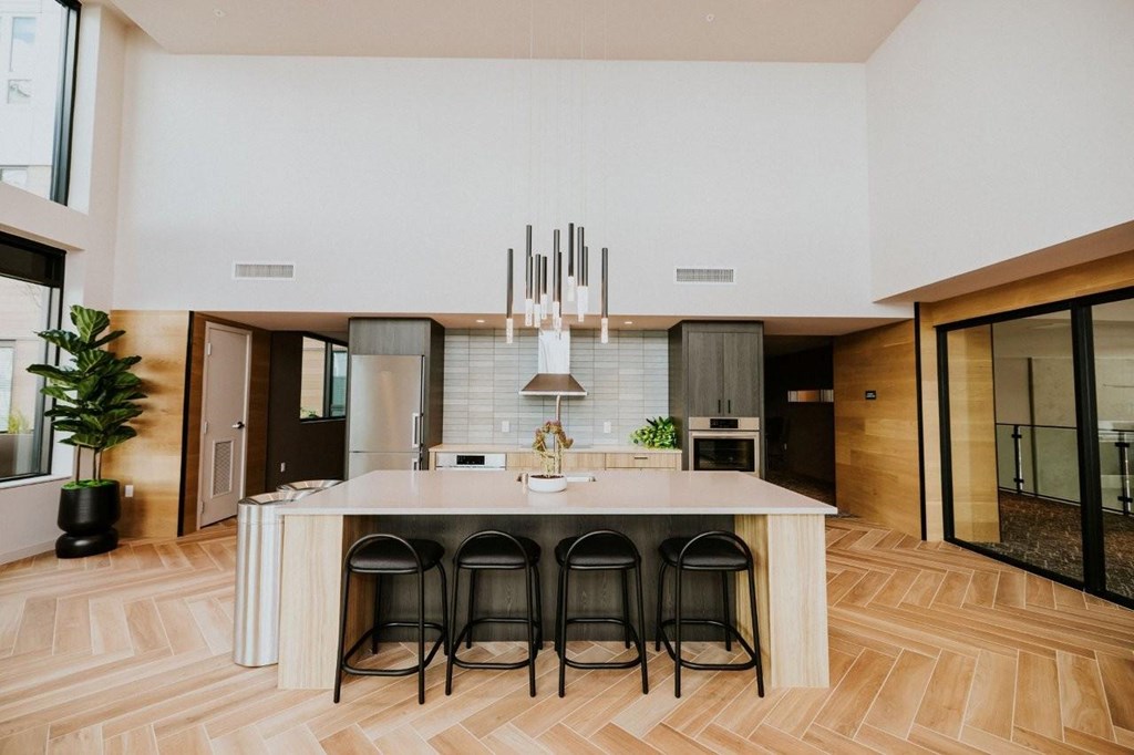 A modern kitchen with a long island and bar stools.