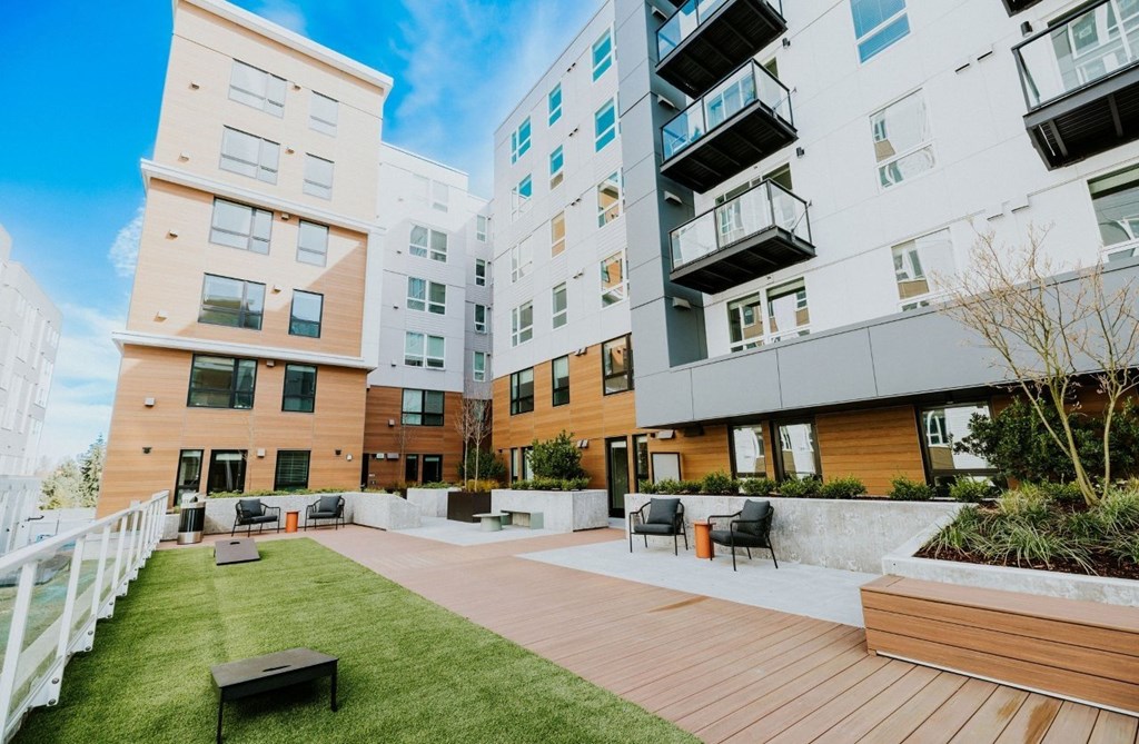 A modern apartment complex with a well-maintained outdoor area.
