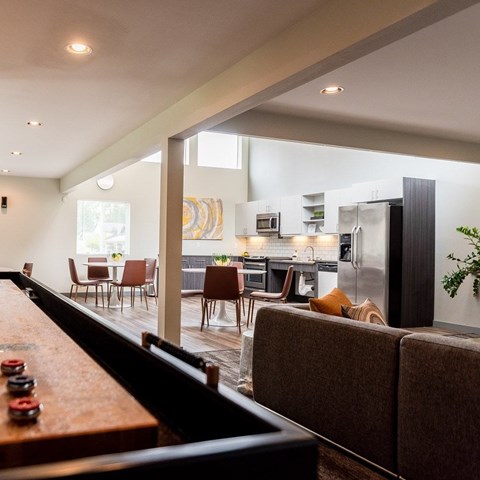 A modern kitchen with a dining table and chairs.